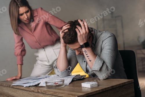 Preview: attractive woman looking at man holding head while having headache