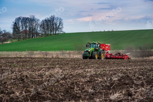 Preview: Farmers sow, apply fertilizer using a tractor with a seeder