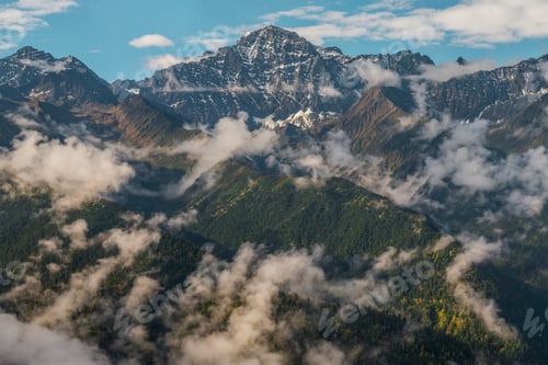 Preview: Picturesque view of top of mountains between clouds