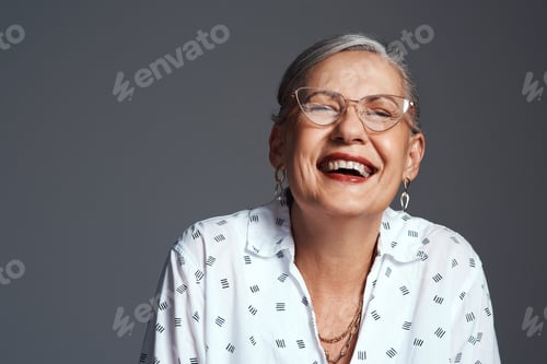Preview: Its just better to be positive. Studio shot of a senior woman posing against a grey background.