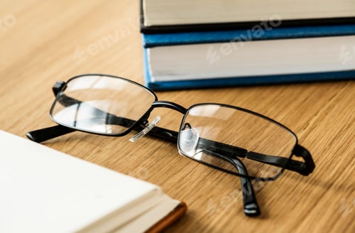Preview: Glasses and Books on a Wood Table