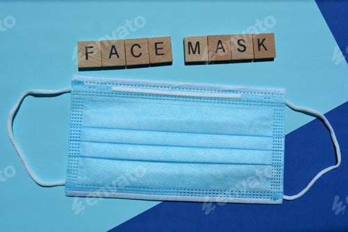 Preview: Face Mask and words in wood letters. Still life concept for protection against coronavirus