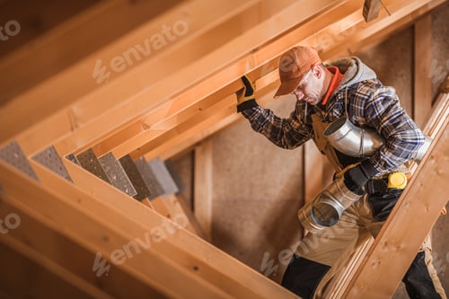 Preview: Skilled Worker Navigating Wooden Beams During Construction in a Residential Attic