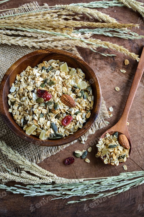 Preview: Oat and whole wheat grains flake in wooden bowl on wooden table