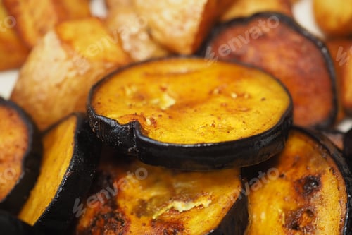 Preview: Grilled eggplant slices with roasted potatoes on a plate