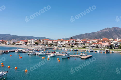 Preview: Peloponnese Paralio Astros port, Arcadia Greece. Aerial drone view of town, moored boat, buoy in sea