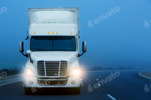 Preview: Commerical Class 8 truck being driven in the fog on a country road.
