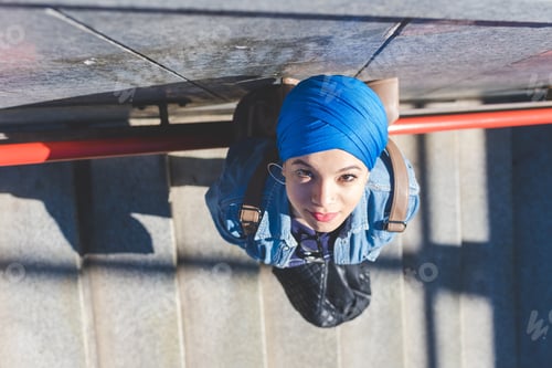 Preview: top view arabian young woman wearing hijab outdoor looking camera smiling