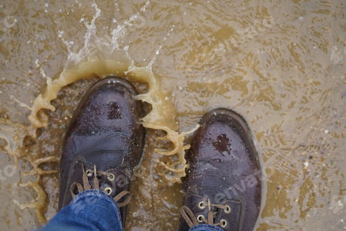 Preview: Leather boots in a puddle