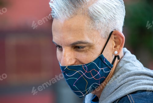Preview: Handsome ethnic man in mask in city
