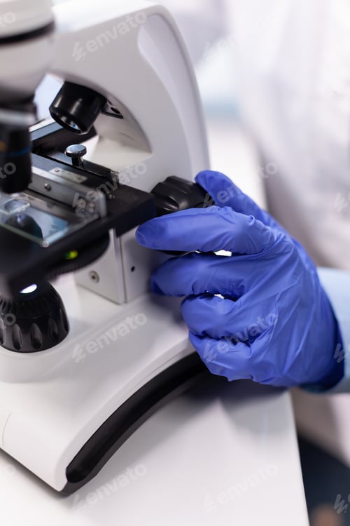 Preview: Pharmacist woman doctor analyzing coronavirus dna test using medical microscope
