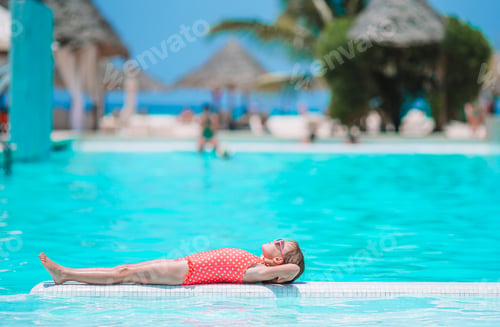 Preview: Little adorable girl in outdoor swimming pool