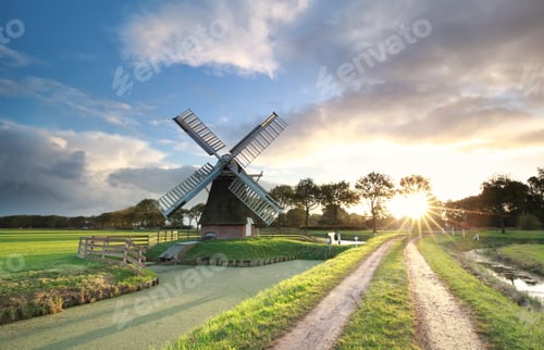 Preview: windmill, rural road and river at sunrise