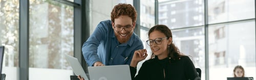 Preview: Two diverse business colleagues disscuss biz issue while use laptop in office background