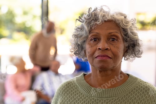 Aperçu: Close-up portrait of serious african american senior woman with multiracial friends in background