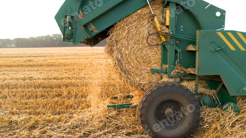Preview: Machine making a round straw bale.