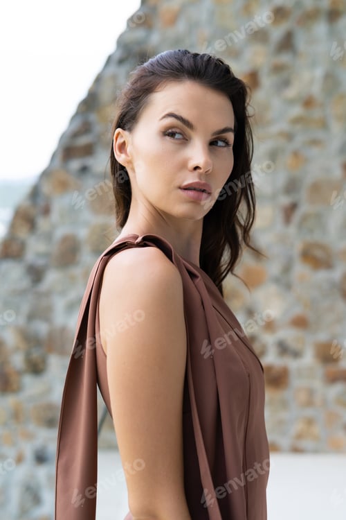 Preview: Fashion portrait of beautiful brunette woman posing in stylish evening dress, outdoor, natural