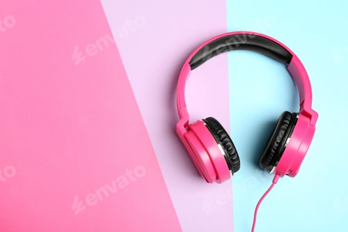 Preview: Stylish headphones on color background, top view. Space for text