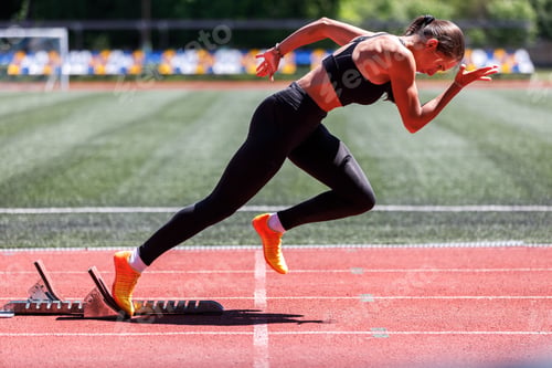 Preview: Young strong sprint sportswoman starting burst from starting blocks
