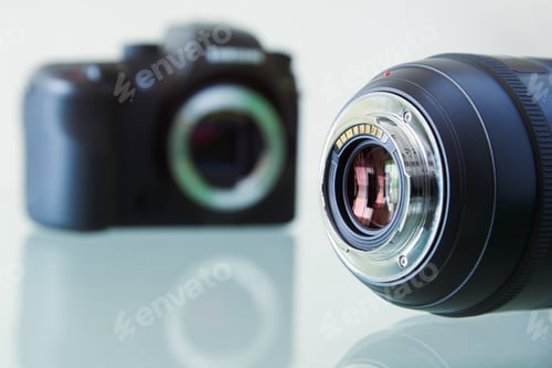Preview: Closeup Of DSLR Photo Camera And Still Lens On Desk