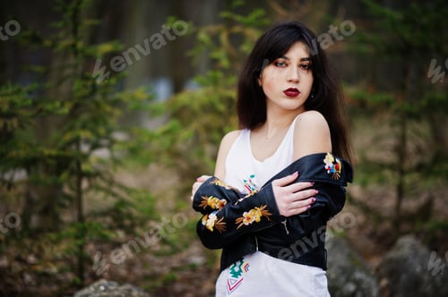 Preview: Brunette gypsy girl posed against stones on park