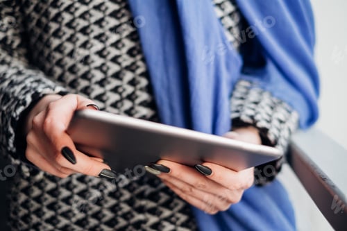 Preview: Woman using tablet on the street