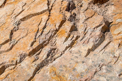 Preview: Raw rough yellow golden brown granite texture background. Natural rock stone texture background