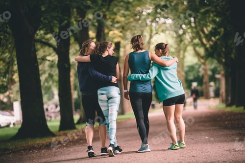 Preview: Four female joggers in park