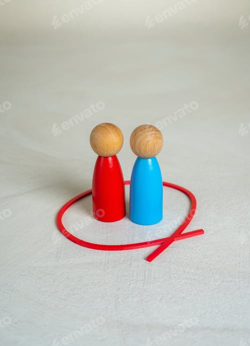Preview: Two figures of human opponents are locked together in a red circle. Working in a team