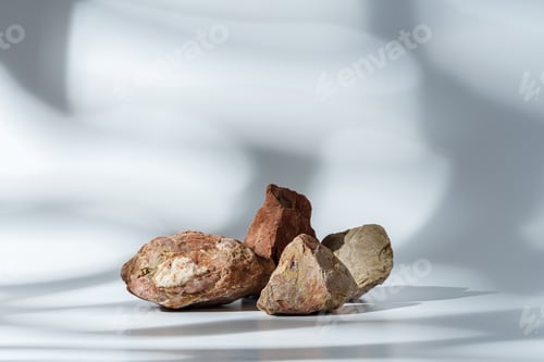 Preview: Piece of granite stone on white background with shadows