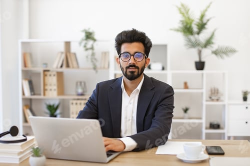 Preview: Indian Businessman Working on Laptop