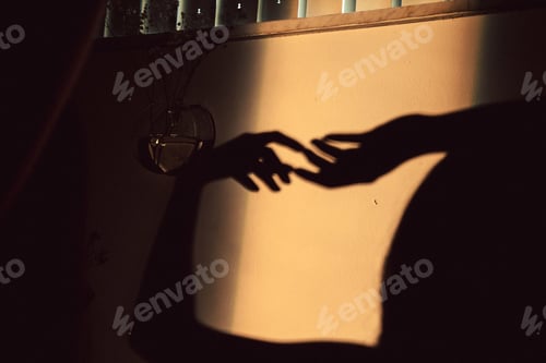 Preview: Shadow of the two hands touching each other on the wall