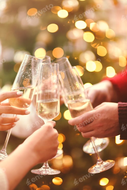 Preview: Unrecognizable people toasting with glasses of champagne