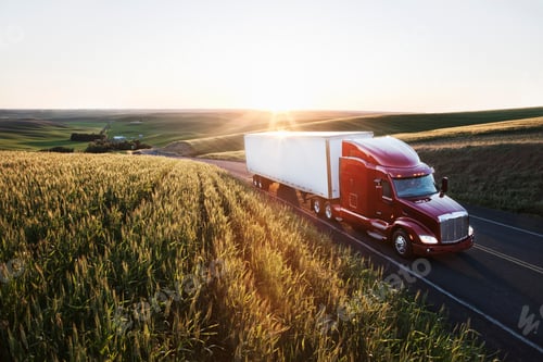 Preview: commercial truck driving though wheat fields of eastern Washington, USA at sunset.