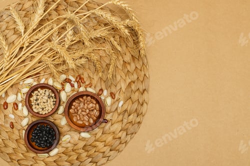 Preview: Flat lay of healthy grains concept, Beans in wooden bowl pistachios and wheat on brown background