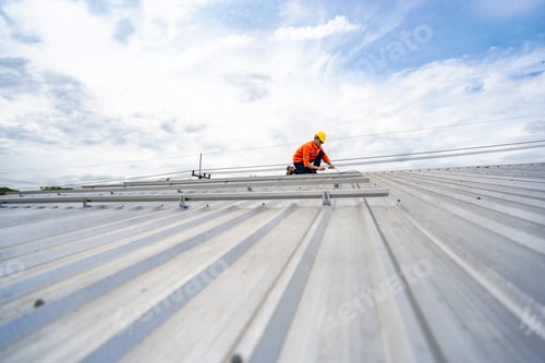 Preview: Two focused industrial technicians work together operating heavy machinery