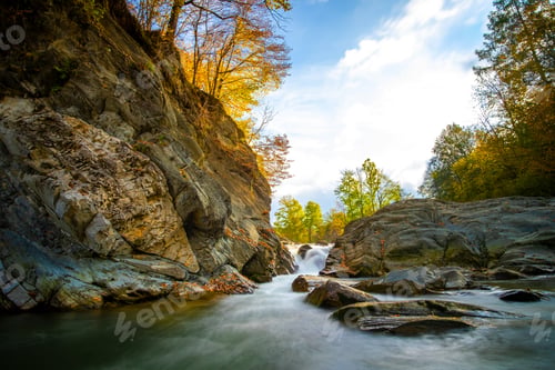 Preview: Mountain river with small waterfall with clear turquoise water falling down