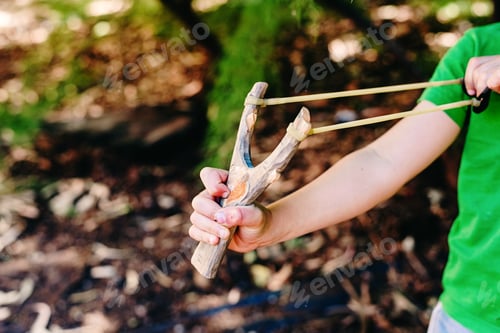 Preview: Boy threatening his schoolmates with a slingshot.
