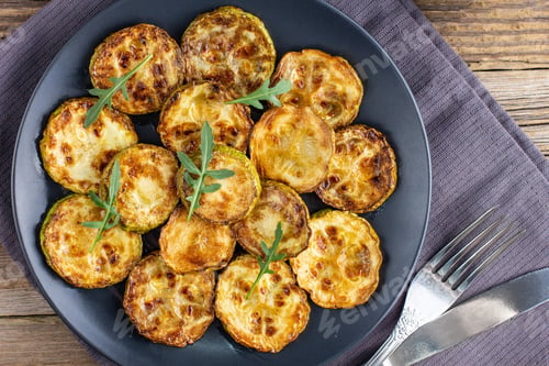 Preview: Fried slices of zucchini with sour cream sauce. Courgettes with herb for dinner