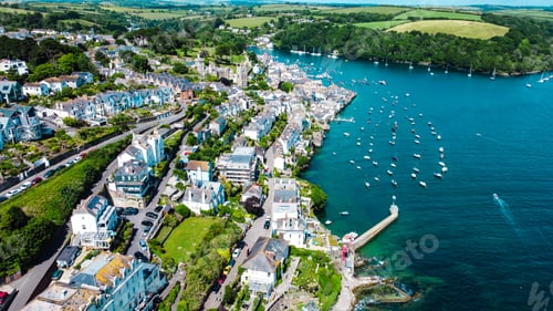 Preview: Aerial shot of the Falmouth Cornwall village on the coast of a beach surrounded by hills