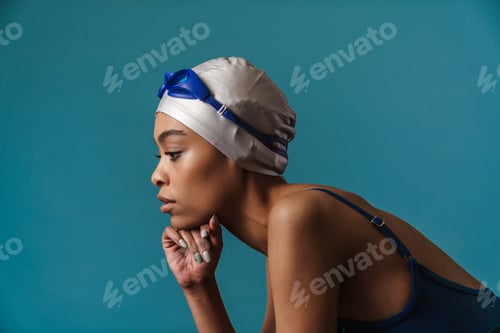 Preview: Young black swimmer in goggles posing and looking aside