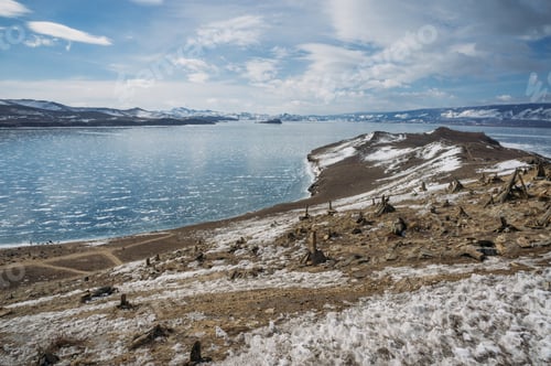 Preview: view of sandy mountain lake shore against water and hills on background, Russia, Lake Baikal