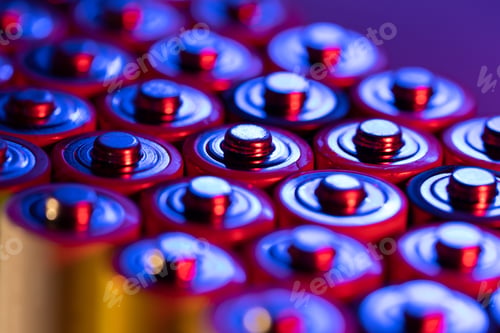 Preview: Closeup of positive ends of discharged batteries AA sizes, macro shot, selective focus. Used battery