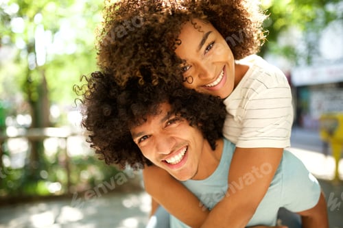 Preview: Close up happy African american man with smiling girlfriend on back