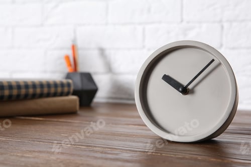 Preview: Modern alarm clock on table indoors. Space for text