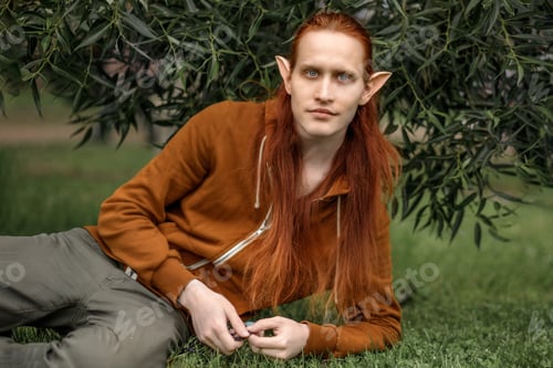 Preview: Artistic elf man with red hair and green eyes in the forest