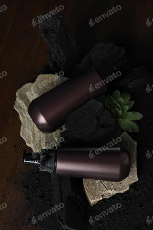 Preview: A bottle with natural, charcoal cosmetics on a wooden background.