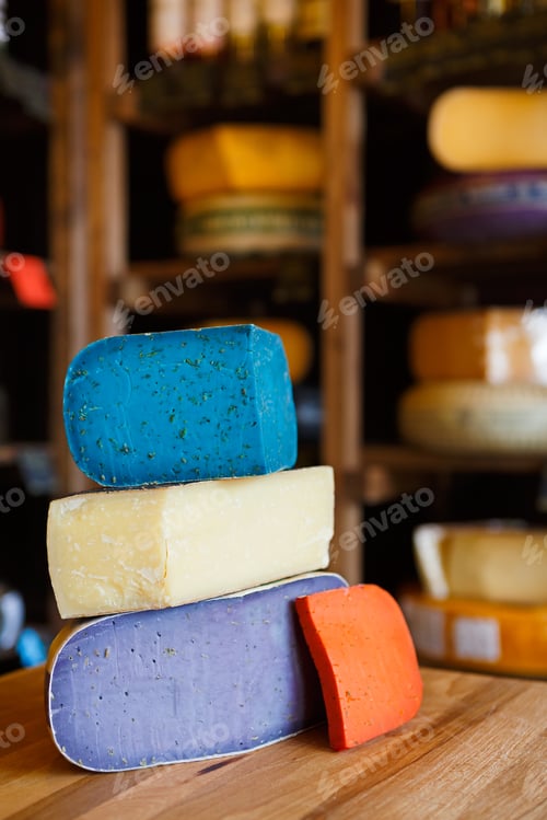 Preview: Gouda pesto cheese assortment. Lavender, blue, violet and red at grocery shop background