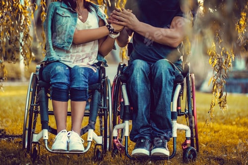 Preview: Couple in Wheelchairs Holding Hands in Golden Light