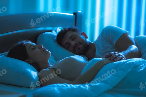 Preview: The young woman sleeping near the man in the bed. night time